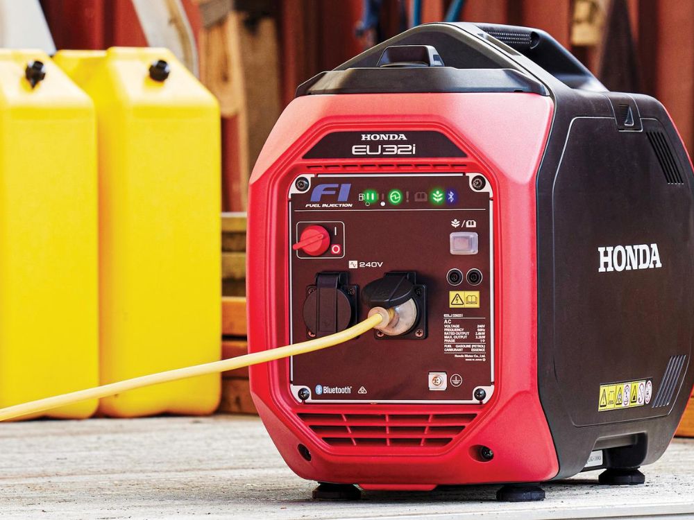 Honda EU32i generator with multiple outlets, connected with a yellow power cord.